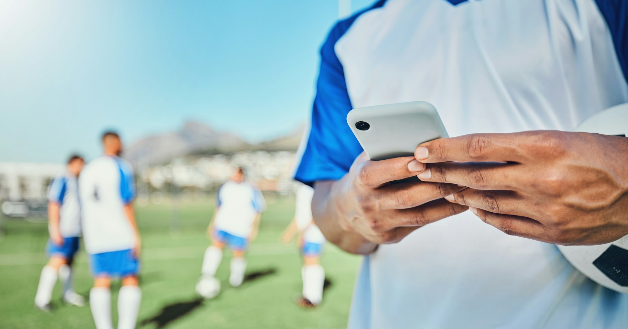 Football, field, phone and man hands for competition, training or fitness news, social media chat a